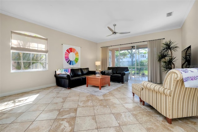 living room with ceiling fan, light tile patterned floors, visible vents, baseboards, and crown molding