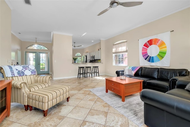 living area featuring ornamental molding, visible vents, plenty of natural light, and ceiling fan