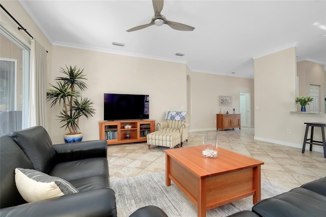 living area featuring ornamental molding, arched walkways, and visible vents