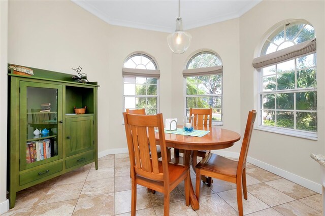 dining space with baseboards, light tile patterned flooring, and crown molding