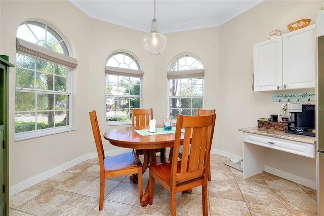 dining area with light tile patterned floors, baseboards, and ornamental molding