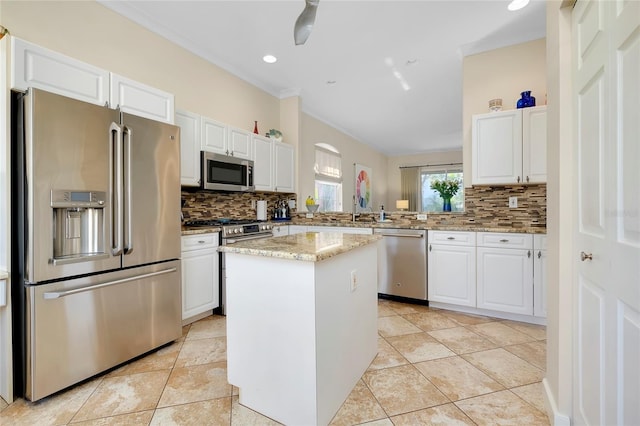 kitchen featuring white cabinetry, appliances with stainless steel finishes, tasteful backsplash, and a center island