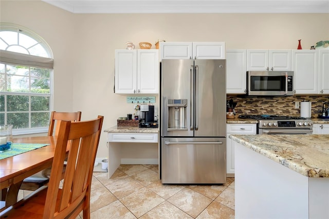 kitchen featuring light tile patterned floors, stainless steel appliances, backsplash, white cabinets, and light stone countertops