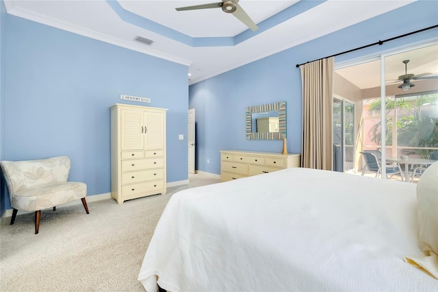 bedroom with light carpet, baseboards, visible vents, access to exterior, and a tray ceiling