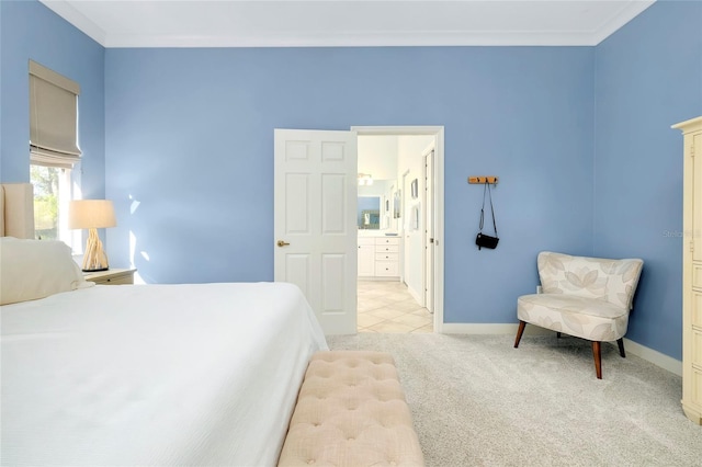 bedroom with crown molding, baseboards, ensuite bath, and light colored carpet