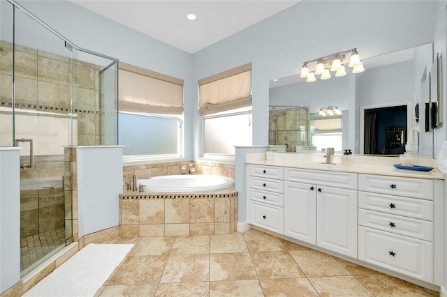 bathroom with a garden tub, vanity, and a stall shower