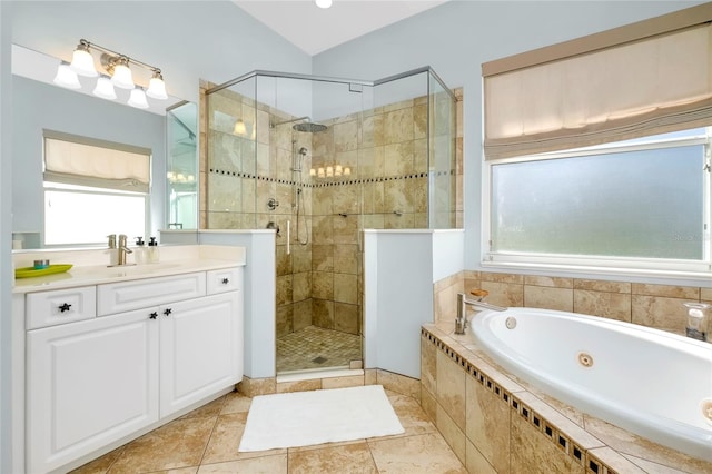 bathroom featuring a jetted tub, a shower stall, and vanity