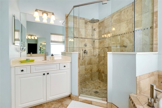 full bathroom featuring a stall shower, vanity, and tile patterned floors