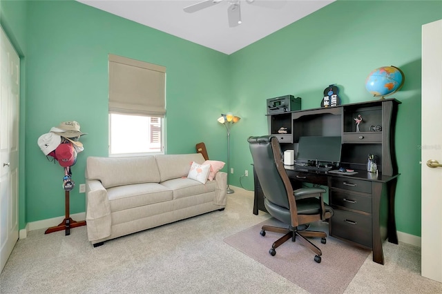 home office with baseboards, a ceiling fan, and light colored carpet