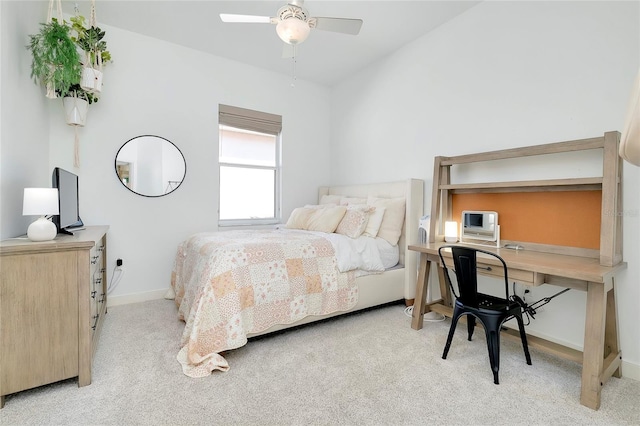 bedroom featuring a ceiling fan, light carpet, and baseboards