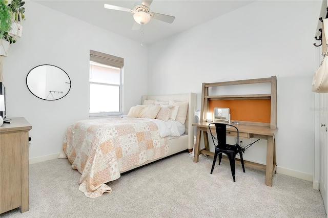 bedroom featuring a ceiling fan, light colored carpet, and baseboards