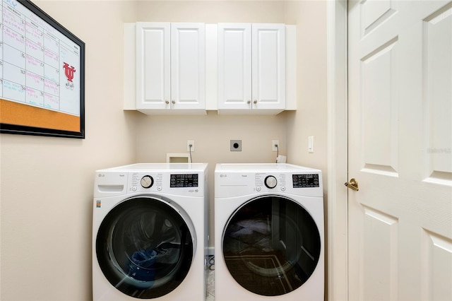 laundry area with washing machine and dryer and cabinet space