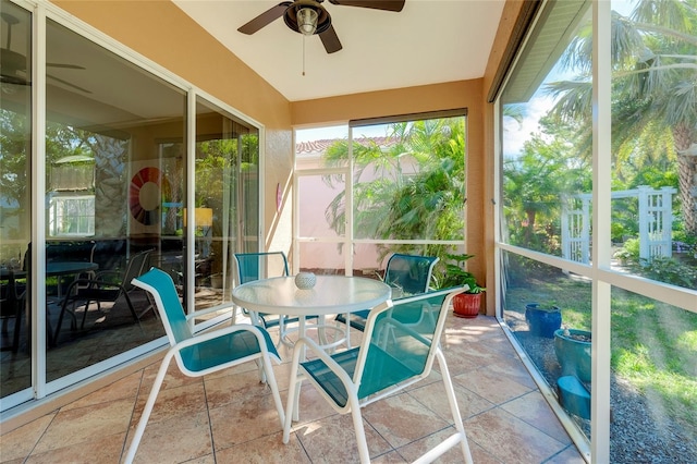 sunroom / solarium featuring vaulted ceiling and a ceiling fan