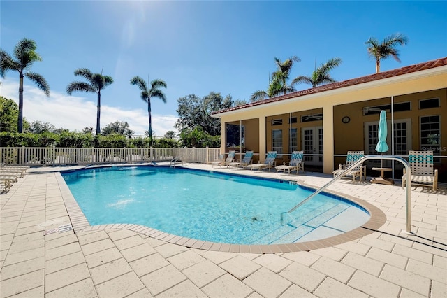 community pool featuring a patio area, fence, and a ceiling fan