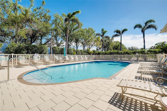 pool featuring a patio area and fence