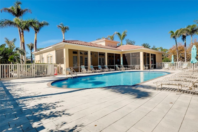 community pool featuring a patio area and fence