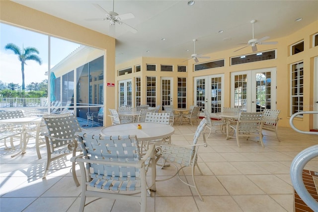 view of patio featuring ceiling fan, outdoor dining area, and french doors