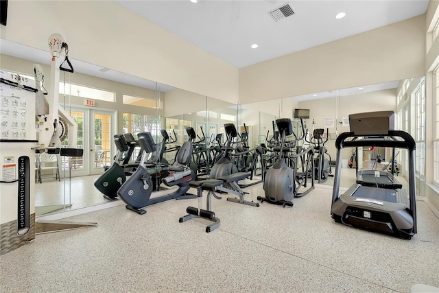 gym with recessed lighting, french doors, visible vents, and a towering ceiling