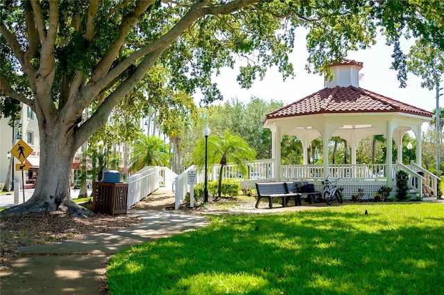 surrounding community with a lawn, a gazebo, and fence