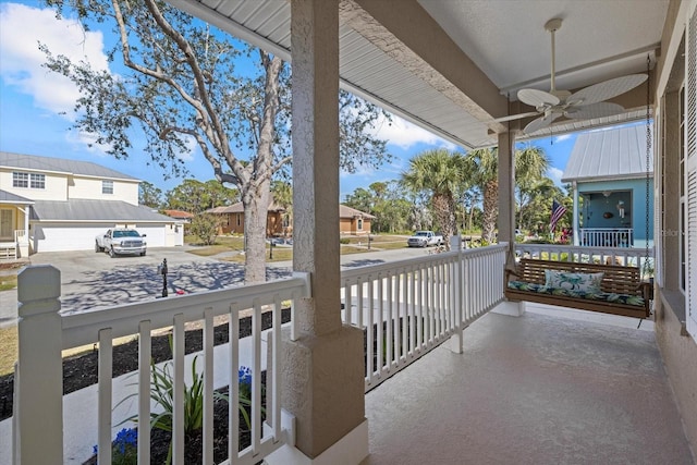 balcony with a porch and ceiling fan