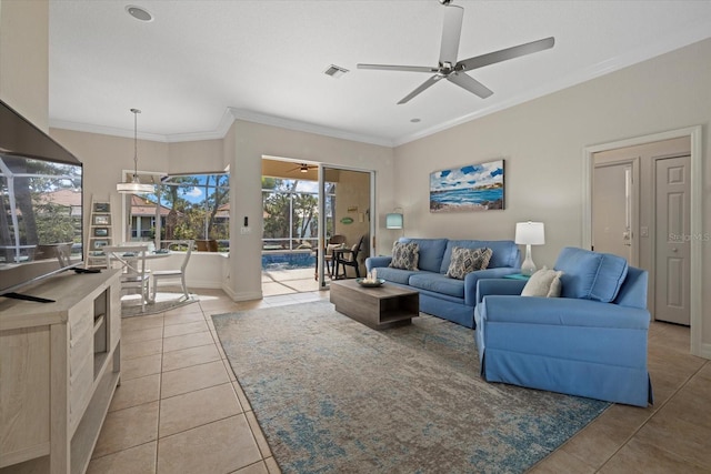 living room with tile patterned flooring, crown molding, and ceiling fan