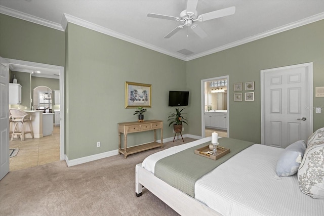 bedroom with crown molding, ensuite bath, ceiling fan, and light carpet