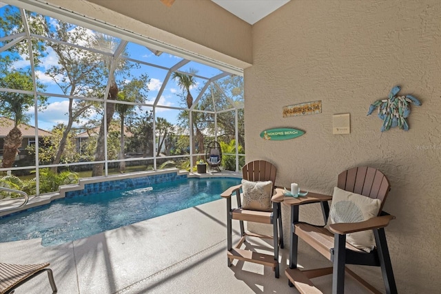 view of pool featuring a patio and glass enclosure