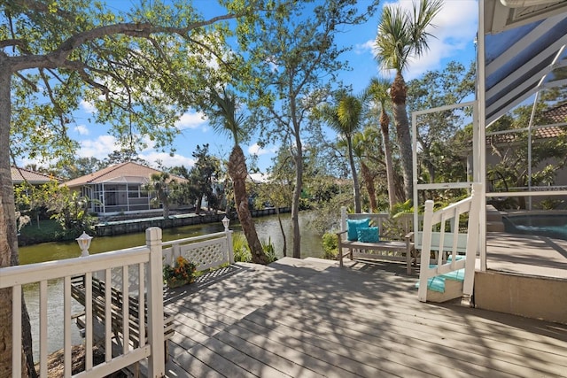 wooden terrace with a lanai and a water view