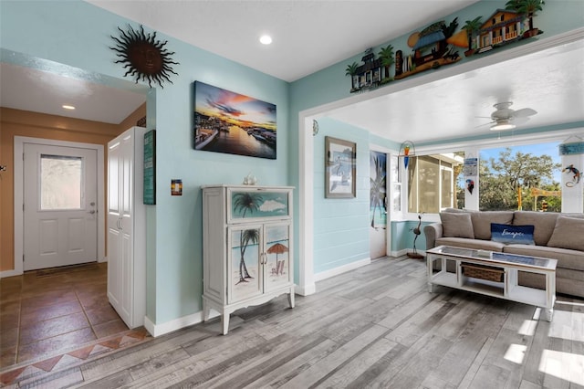 hall with light wood finished floors, baseboards, and recessed lighting