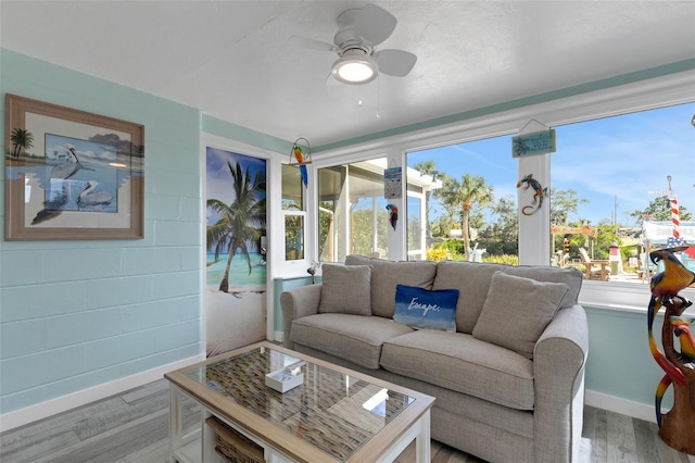 sunroom / solarium featuring ceiling fan and a wealth of natural light