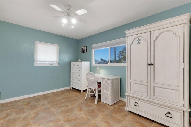 home office with a healthy amount of sunlight, ceiling fan, and baseboards