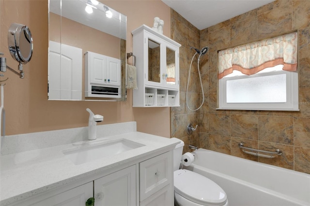 bathroom featuring washtub / shower combination, vanity, and toilet