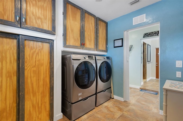 laundry room with cabinet space, baseboards, visible vents, and washer and dryer