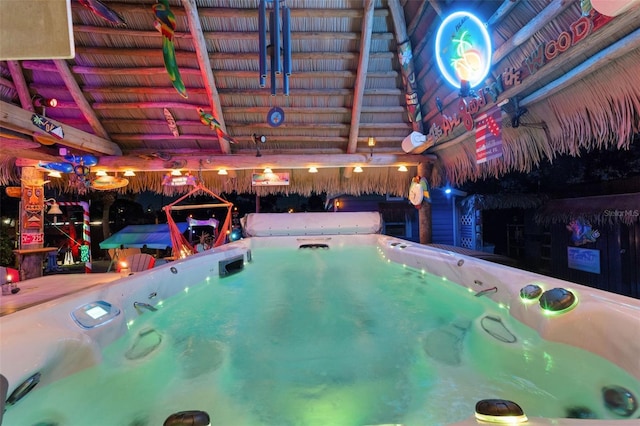 view of swimming pool with a hot tub