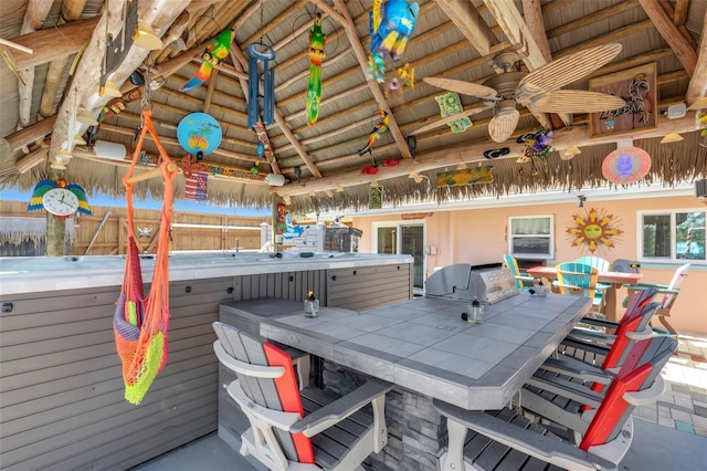 wooden deck with ceiling fan, a hot tub, outdoor dry bar, and a gazebo