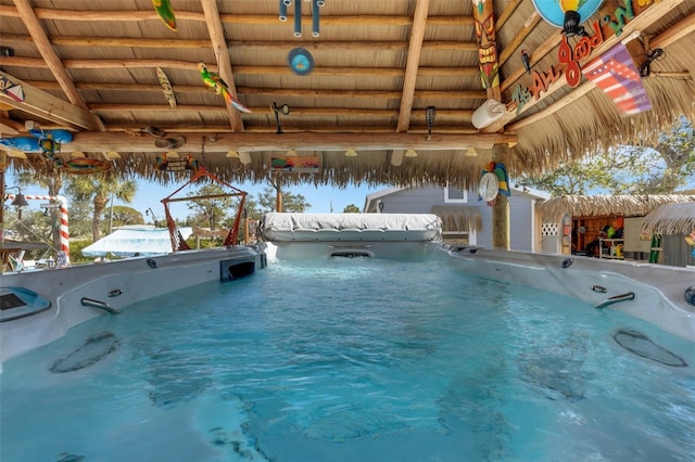 view of pool with a hot tub