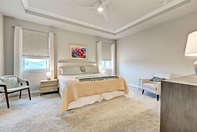 bedroom with a tray ceiling, ornamental molding, and light colored carpet