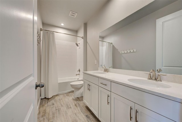 full bathroom with vanity, hardwood / wood-style flooring, toilet, and shower / bath combo with shower curtain