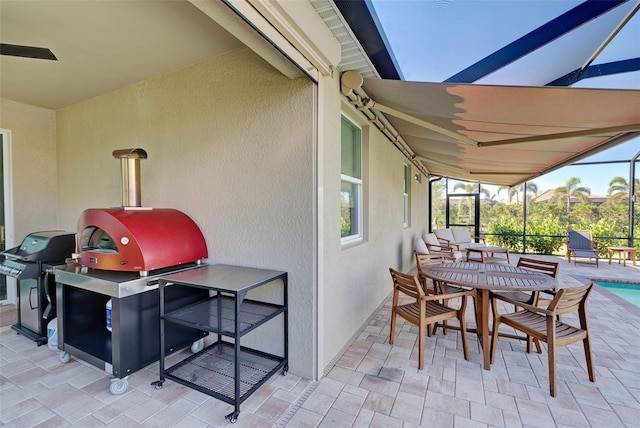 view of patio featuring grilling area and glass enclosure