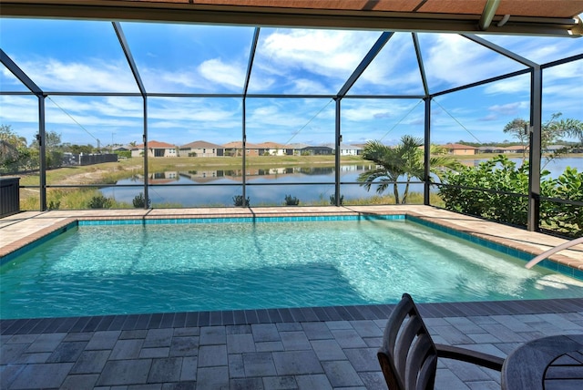 view of pool with a lanai, a patio, and a water view