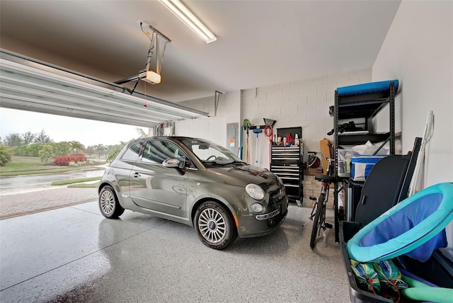 garage featuring a garage door opener and electric panel