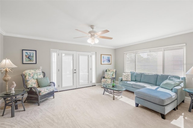 carpeted living room featuring ornamental molding, french doors, and ceiling fan