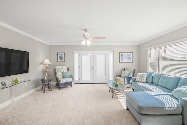 living room with ceiling fan, light colored carpet, and ornamental molding