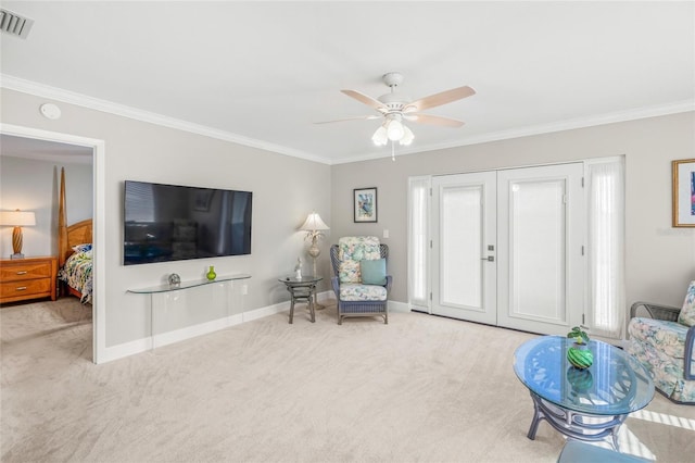 living area featuring crown molding, light colored carpet, and ceiling fan