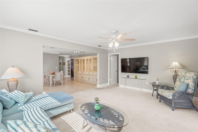 carpeted living room featuring crown molding and ceiling fan