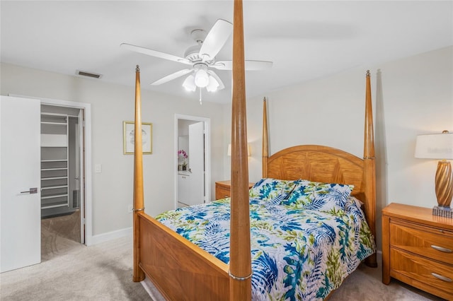 carpeted bedroom with ceiling fan and a closet