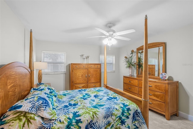 bedroom with multiple windows, light colored carpet, and ceiling fan