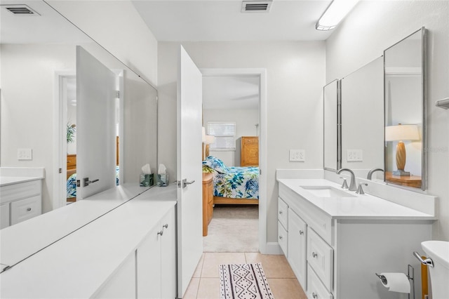 bathroom with tile patterned floors and vanity