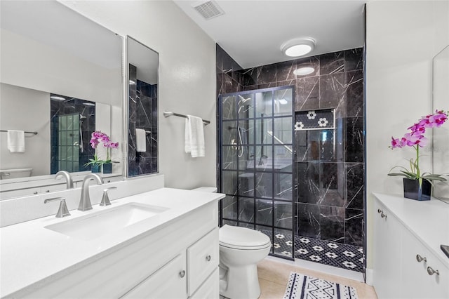 bathroom with an enclosed shower, vanity, tile patterned floors, and toilet