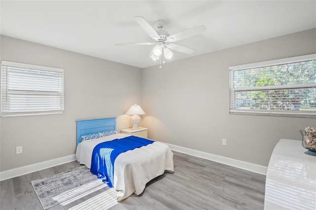 bedroom with hardwood / wood-style flooring and ceiling fan